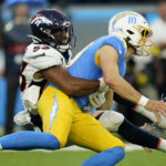 
              Denver Broncos linebacker Jonathon Cooper (53) causes Los Angeles Chargers quarterback Justin Herbert (10) to fumble on a hit during the first half of an NFL football game, Monday, Oct. 17, 2022, in Inglewood, Calif. The Chargers recovered the football. (AP Photo/Marcio Jose Sanchez)
            