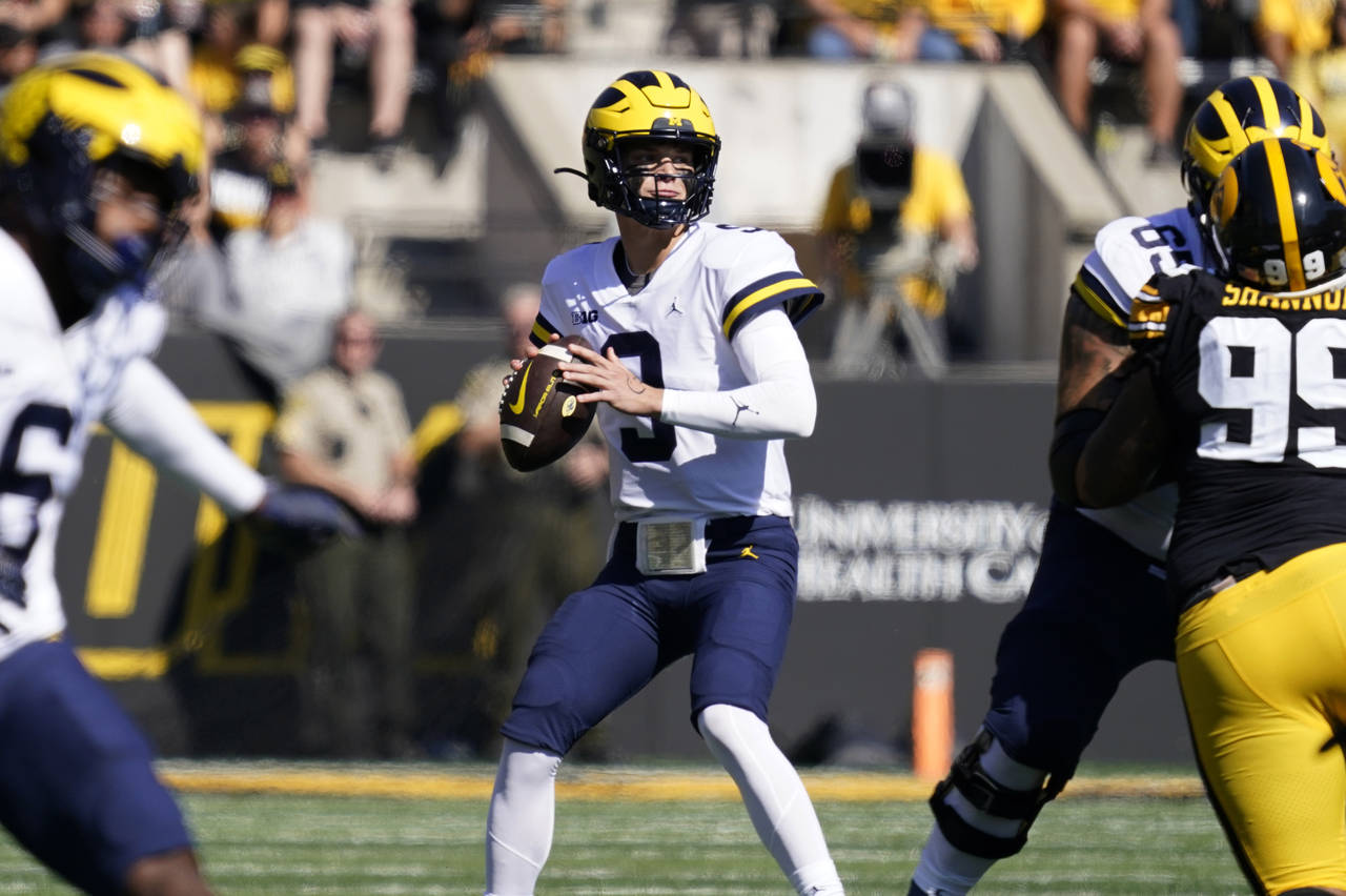 Michigan quarterback J.J. McCarthy (9) looks to pass during the first half of an NCAA college footb...