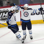 
              Winnipeg Jets center Adam Lowry, left, celebrates with defenseman Neal Pionk, who scored in overtime against the Colorado Avalanche during an NHL hockey game Wednesday, Oct. 19, 2022, in Denver. (AP Photo/David Zalubowski)
            