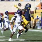 
              West Virginia wide receiver Bryce Ford-Wheaton (0) catches a pass as TCU cornerback Kee'Yon Stewart (2) defends during the first half of an NCAA college football game in Morgantown, W.Va., Saturday, Oct. 29, 2022. (AP Photo/Kathleen Batten)
            