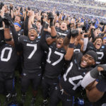 
              Air Force players sing the school song with cadets after an NCAA college football game against Navy, Saturday, Oct. 1, 2022, at Air Force Academy, Colo. (AP Photo/David Zalubowski)
            