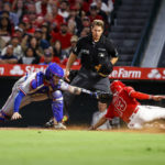 
              Los Angeles Angels' Livan Soto, right, scores as Texas Rangers catcher Jonah Heim applies a late tag during the seventh inning of a baseball game in Anaheim, Calif., Saturday, Oct. 1, 2022. (AP Photo/Ringo H.W. Chiu)
            
