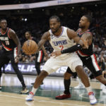 
              Los Angeles Clippers' Kawhi Leonard (2) draws a foul from Portland Trailblazers' Damian Lillard, behind,  during the first half of a preseason NBA basketball game, Monday, Oct. 3, 2022, in Seattle. (AP Photo/ John Froschauer)
            