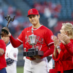 
              Los Angeles Angels' Shohei Ohtani, center, receives the Nick Adenhart Pitcher of the Year and Angels team MVP awards prior to the team's baseball game against the Texas Rangers in Anaheim, Calif., Saturday, Oct. 1, 2022. (AP Photo/Ringo H.W. Chiu)
            