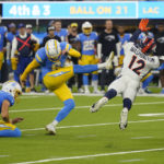 
              Los Angeles Chargers place kicker Dustin Hopkins (6) kicks the game winning field goal as Denver Broncos wide receiver Montrell Washington (12) tries to block it during the second half of an NFL football game, Monday, Oct. 17, 2022, in Inglewood, Calif. The Chargers defeated the Broncos 19-16 in overtime. (AP Photo/Mark J. Terrill)
            