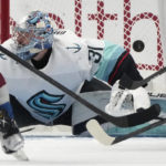 
              Seattle Kraken goaltender Philipp Grubauer deflects a shot during the second period of the team's NHL hockey game against the Colorado Avalanche on Friday, Oct. 21, 2022, in Denver. (AP Photo/David Zalubowski)
            