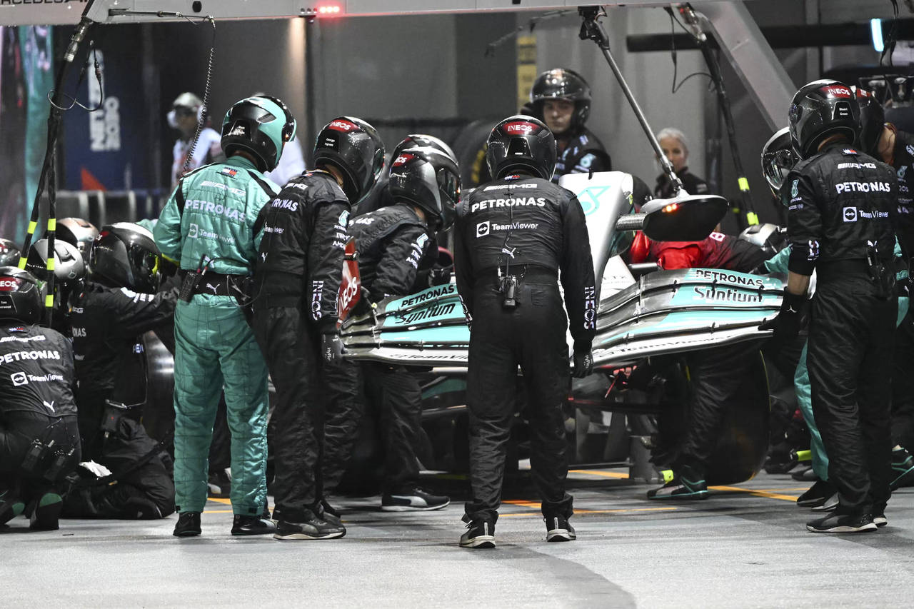 Mechanics change the front wing on Mercedes driver Lewis Hamilton of Britain's car during the Singa...
