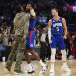 
              LA Clippers forward Paul George, center, celebrates with guard John Wall, left, and guard Luke Kennard (5) after making a shot during the second half of an NBA basketball game against the Houston Rockets in Los Angeles, Monday, Oct. 31, 2022. (AP Photo/Ashley Landis)
            