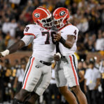 
              Georgia's Nolan Smith (4) and Nazir Stackhouse (78) celebrate after a sack by Smith during the second half of an NCAA college football game against Missouri Saturday, Oct. 1, 2022, in Columbia, Mo. (AP Photo/L.G. Patterson)
            