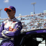 
              Driver Denny Hamlin leans on his car before a NASCAR Cup Series auto race at Homestead-Miami Speedway, Sunday, Oct. 23, 2022, in Homestead, Fla. (AP Photo/Terry Renna)
            