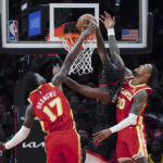 
              Houston Rockets guard Josh Christopher goes in for a basket as Atlanta Hawks forwards Onyeka Okongwu (17) and John Collins (20) defend during the first half of an NBA basketball game Wednesday, Oct. 19, 2022, in Atlanta. (AP Photo/John Bazemore)
            