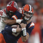 
              North Carolina State safety Tanner Ingle (10) tackles Syracuse quarterback Garrett Shrader, right, during the second half of an NCAA college football game Saturday, Oct. 15, 2022, in Syracuse, N.Y. (AP Photo/Joshua Bessex)
            