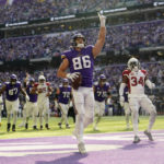 
              Minnesota Vikings tight end Johnny Mundt (86) celebrates ahead of Arizona Cardinals safety Jalen Thompson (34) after catching a 1-yard touchdown pass during the first half of an NFL football game, Sunday, Oct. 30, 2022, in Minneapolis. (AP Photo/Abbie Parr)
            