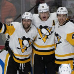 
              Pittsburgh Penguins' Evgeni Malkin, center, celebrates his goal against the Montreal Canadiens with teammates Jason Zucker, left, and Jan Rutta during second-period NHL hockey game action in Montreal, Monday, Oct. 17, 2022. (Paul Chiasson/The Canadian Press via AP)
            