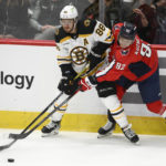 
              Washington Capitals center Evgeny Kuznetsov (92) works for the puck against Boston Bruins right wing David Pastrnak (88) during the third period of an NHL hockey game Wednesday, Oct. 12, 2022, in Washington. The Bruins won 5-2. (AP Photo/Nick Wass)
            