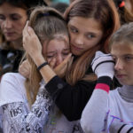 
              Participants cry while listening to a speech by a victim of domestic violence during a protest aiming to raise awareness to the violence and prejudice against women in Romanian society in Bucharest, Romania, Sunday, Oct. 23, 2022. Participants called for better support and protection for the victims of violence and the implementation of a national strategy to ensure gender equality and combat domestic violence. (AP Photo/Andreea Alexandru)
            