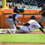 
              Detroit Tigers designated hitter Miguel Cabrera, right, slides into third base past the reach of Minnesota Twins third baseman Gio Urshela after a wild pitch by starting pitcher Simeon Woods Richardson during the first inning of a baseball game, Sunday, Oct. 2, 2022, in Detroit. (AP Photo/Jose Juarez)
            