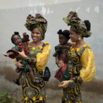 
              Twins Oladapo Taiwo, left, and Oladapo Kehinde, 21, pose for photographs holding relative's twins during the annual twins festival in Igbo-Ora South west Nigeria, Saturday, Oct. 8, 2022. The town holds the annual festival to celebrate the high number of twins and multiple births. (AP Photo/Sunday Alamba)
            