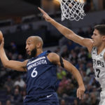 
              Minnesota Timberwolves guard Jordan McLaughlin (6) passes while defended by San Antonio Spurs forward Doug McDermott (17) during the first half of an NBA basketball game, Wednesday, Oct. 26, 2022, in Minneapolis. (AP Photo/Abbie Parr)
            