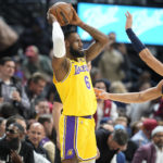 
              Los Angeles Lakers forward LeBron James, left, looks to pass the ball as Denver Nuggets forward Aaron Gordon defends in the first half of an NBA basketball game Wednesday, Oct. 26, 2022, in Denver. (AP Photo/David Zalubowski)
            