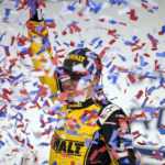
              Christopher Bell celebrates in Victory Lane after winning a NASCAR Cup Series auto race at Charlotte Motor Speedway, Sunday, Oct. 9, 2022, in Concord, N.C. (AP Photo/Matt Kelley)
            