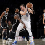 
              Brooklyn Nets guard Kyrie Irving (11) defends against Dallas Mavericks guard Luka Doncic (77) during overtime of an NBA basketball game, Thursday, Oct. 27, 2022, in New York. (AP Photo/John Minchillo)
            