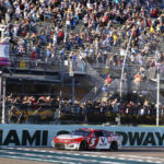 
              Kyle Larson (5) takes the checkered flag to win a NASCAR Cup Series auto race at Homestead-Miami Speedway, Sunday, Oct. 23, 2022, in Homestead, Fla. (AP Photo/Terry Renna)
            
