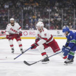 
              Carolina Hurricanes' Jordan Staal (11) and Vancouver Canucks' Jack Rathbone (3) vie for the puck during the first period of an NHL hockey game in Vancouver, British Columbia, on Monday, Oct. 24, 2022. (Darryl Dyck/The Canadian Press via AP)
            