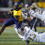 
              Washington linebacker Kamren Fabiculanan (13) and safety Asa Turner (20) tackle California wide receiver J. Michael Sturdivant (7) after a catch during the first half of an NCAA college football game in Berkeley, Calif., Saturday, Oct. 22, 2022. (AP Photo/Godofredo A. Vásquez)
            