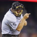 
              FILE - Home plate umpire Dale Scott signals during the seventh inning of a baseball game between the Detroit Tigers and the Los Angeles Angels, Wednesday, Aug. 26, 2015, in Detroit. A rule change at the beginning of the season designed to explain on-field call challenges and outcomes introduced umpires’ voices to ballpark speakers, to the fans in their seats and to the world at home for the first time. Scott, now retired, couldn't be more pleased. “I would have loved to have done it," he says. (AP Photo/Carlos Osorio, File)
            