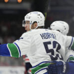 
              Vancouver Canucks center Bo Horvat (53) celebrates his goal with defenseman Quinn Hughes (43) during the second period of an NHL hockey game against the Washington Capitals, Monday, Oct. 17, 2022, in Washington. (AP Photo/Jess Rapfogel)
            