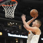 
              Denver Nuggets center Nikola Jokic (15) goes up for a shot against the Utah Jazz during the second quarter of an NBA basketball game Friday, Oct. 28, 2022, in Denver. (AP Photo/Jack Dempsey)
            