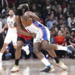 
              Philadelphia 76ers' James Harden, front, is fouled by Toronto Raptors' Scottie Barnes during first-half NBA basketball game action in Toronto, Friday, Oct. 28, 2022. (Chris Young/The Canadian Press via AP)
            