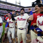 
              The Philadelphia Phillies celebrate a win over the Atlanta Braves after Game 4 of baseball's National League Division Series, Saturday, Oct. 15, 2022, in Philadelphia. The Philadelphia Phillies won, 8-3. (AP Photo/Matt Rourke)
            
