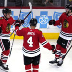 
              Chicago Blackhawks center Max Domi, left, celebrates with defenseman Seth Jones and right wing Taylor Raddysh, right, after scoring his goal during the second period of an NHL hockey game against the Edmonton Oilers in Chicago, Thursday, Oct. 27, 2022. (AP Photo/Nam Y. Huh)
            