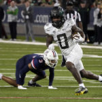 
              Oregon running back Bucky Irving (0) scores a touchdown against Arizona during the second half of an NCAA college football game Saturday, Oct. 8, 2022, in Tucson, Ariz. (AP Photo/Rick Scuteri)
            