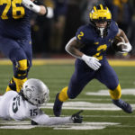 
              Michigan running back Blake Corum (2) escapes Michigan State safety Angelo Grose (15) in the first half of an NCAA college football game in Ann Arbor, Mich., Saturday, Oct. 29, 2022. (AP Photo/Paul Sancya)
            