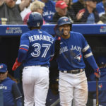 
              Toronto Blue Jays outfielder Teoscar Hernandez (37) celebrates with teammate George Springer after scoring on a single by catcher Danny Jensen during the second inning of a baseball game against the Boston Red Sox in Toronto on Saturday, Oct. 1, 2022. (Christopher Katsarov/The Canadian Press via AP)
            