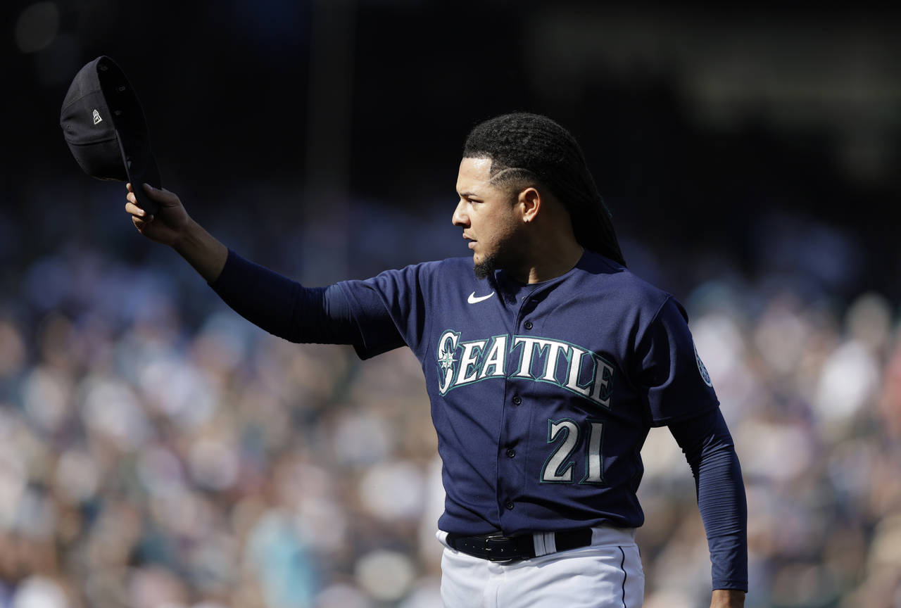 Seattle Mariners starting pitcher Luis Castillo tips his cap as he walks off the field after pitchi...