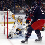 
              Nashville Predators goalie Kevin Lankinen, left, stops a shot in front of Columbus Blue Jackets forward Jack Roslovic during the second period of an NHL hockey game in Columbus, Ohio, Thursday, Oct. 20, 2022. (AP Photo/Paul Vernon)
            