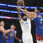
              Los Angeles Lakers forward Anthony Davis (3) grabs a rebound from Denver Nuggets forward Michael Porter Jr. (1) during the first half of an NBA basketball game, Sunday, Oct. 30, 2022, in Los Angeles. (AP Photo/Michael Owen Baker)
            