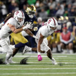 
              Stanford safety Jonathan McGill, right, and cornerback Ethan Bonner, left, and Notre Dame wide receiver Jayden Thomas chase a fumble during the second half of an NCAA college football game in South Bend, Ind., Saturday, Oct. 15, 2022. Stanford won 16-14. (AP Photo/Nam Y. Huh)
            