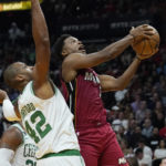 
              Miami Heat guard Kyle Lowry (7) drives to the basket as Boston Celtics center Al Horford (42) defends during the first half of an NBA game, Friday, Oct. 21, 2022, in Miami. (AP Photo/Marta Lavandier)
            