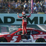 
              Kyle Larson celebrates after winning a NASCAR Cup Series auto race at Homestead-Miami Speedway, Sunday, Oct. 23, 2022, in Homestead, Fla. (AP Photo/Lynne Sladky)
            