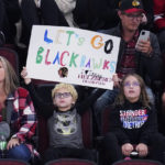 
              A Chicago Blackhawks fan holds a sign during the third period of an NHL hockey game against the Seattle Kraken in Chicago, Sunday, Oct. 23, 2022. The Blackhawks won 5-4.(AP Photo/Nam Y. Huh)
            
