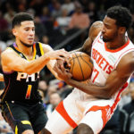 
              Phoenix Suns' Devin Booker (1) and Houston Rockets' Tari Eason (17) battle for the ball during the first half of an NBA basketball game, Sunday, Oct. 30, 2022, in Phoenix. (AP Photo/Darryl Webb)
            