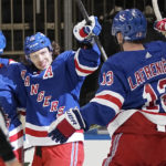 
              New York Rangers left wing Artemi Panarin, center, celebrates his goal against the San Jose Sharks with teammate Alexis Lafreniere (13) during the second period of an NHL hockey game, Thursday, Oct. 20, 2022, in New York. (AP Photo/Eduardo Munoz Alvarez)
            