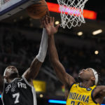 
              Indiana Pacers guard Buddy Hield , right, fights for a rebound against San Antonio Spurs guard Josh Richardson (7) during the second half of an NBA basketball game in Indianapolis, Friday, Oct. 21, 2022. (AP Photo/AJ Mast)
            