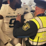
              Security and police break up a scuffle between players from Michigan and Michigan State football teams in the Michigan Stadium tunnel after an NCAA college football game on Saturday, Oct. 29, 2022 in Ann Arbor, Mich.  Michigan State President Samuel Stanley has apologized and says the actions of the football players who were involved in a postgame melee with Michigan players are “unacceptable.” He also says the players involved would be held responsible by coach Mel Tucker.   (Kyle Austin/MLive Media Group via AP)
            