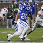
              Duke's Jaquez Moore (20) carries the ball for a touchdown past Virginia's Langston Long, left, and Darrius Bratton (8) during the second half of an NCAA college football game in Durham, N.C., Saturday, Oct. 1, 2022. (AP Photo/Ben McKeown)
            